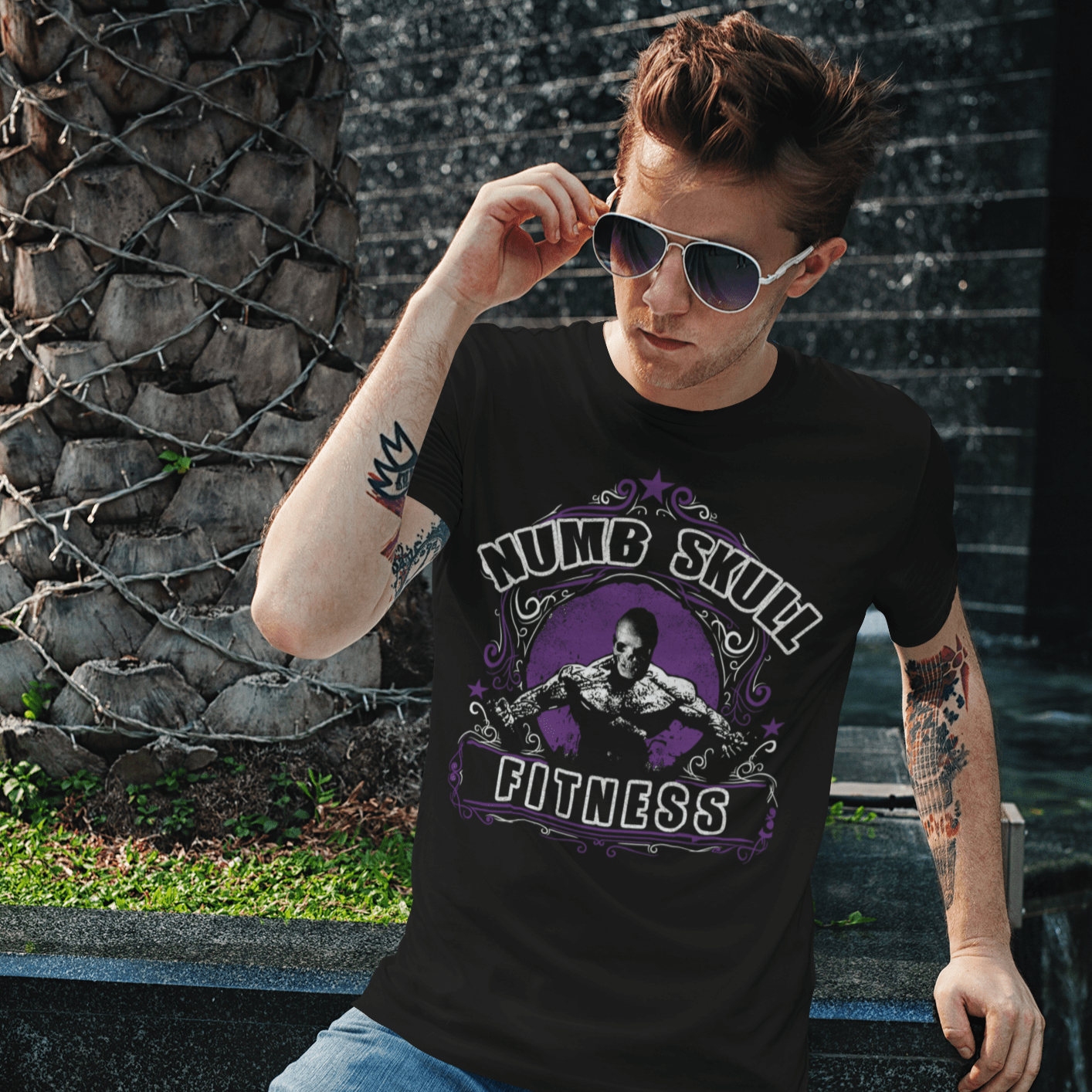 young cool man wearing sunglasses with Numb Skull fitness tee graphic